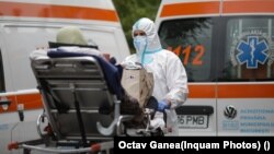 Ambulances wait in front of the University Hospital in Bucharest to hospitalize patients.
