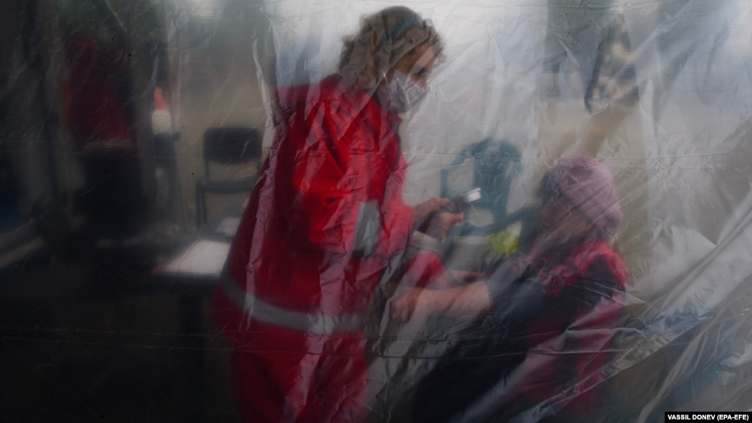 A woman receives an examination before being given a coronavirus vaccine in the village of Krushovitsa, Bulgaria.