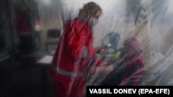 A woman receives an examination before being given a coronavirus vaccine in the village of Krushovitsa, Bulgaria.