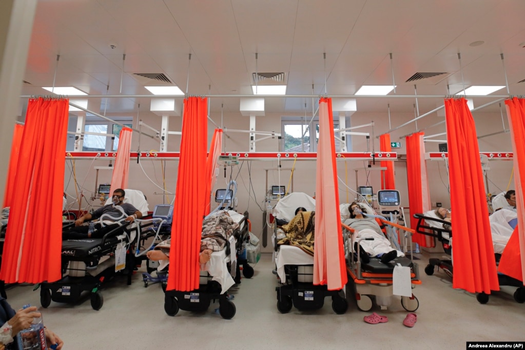 Patients lie on beds in an emergency room that has been turned into a COVID-19 unit due to the high number of cases, at the Bagdasar-Arseni hospital in Bucharest.