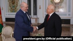 Alyaksandr Lukashenka (left) greets Dmitry Kiselyov in Minsk on November 30.