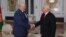Alyaksandr Lukashenka (left) greets Dmitry Kiselyov in Minsk on November 30.