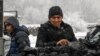 A man in Bishkek stands next to a truck loaded with coal that people can buy at reduced prices to heat their homes amid an energy crunch in Kyrgyzstan.&nbsp;