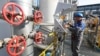 A worker checks measuring equipment at the Slavyanskaya compressor station, the starting point of the Nord Stream 2 pipeline.