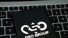 NSO Group logo seen on the smartphone placed on laptop keyboard. Israeli company known for its Pegasus spyware for surveillance.