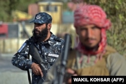 Taliban fighters working as police at a checkpoint in Kabul in October.