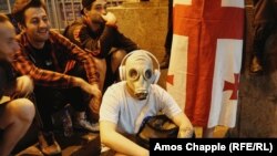 A demonstrator with a gas mask sits outside the parliament building on June 22.