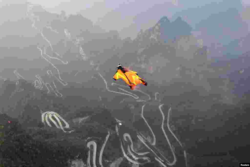 Wingsuit flyer Melissa Pemberton of the United States jumps off a mountain at Tianmen Mountain National Park in Zhangjiajie, Hunan Province, China. (Reuters/China Daily)