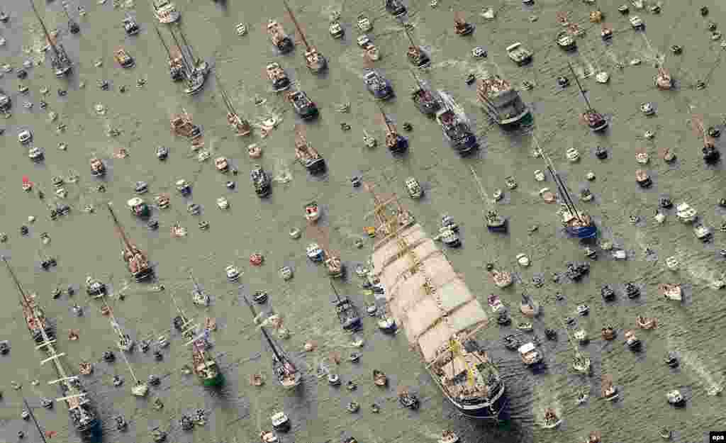 An aerial photo of the clipper ship Stad Amsterdam, accompanied by smaller vessels, as it makes its way to Amsterdam to join a flotilla of large ships. (epa/Robin Van Lonkhuijsen)