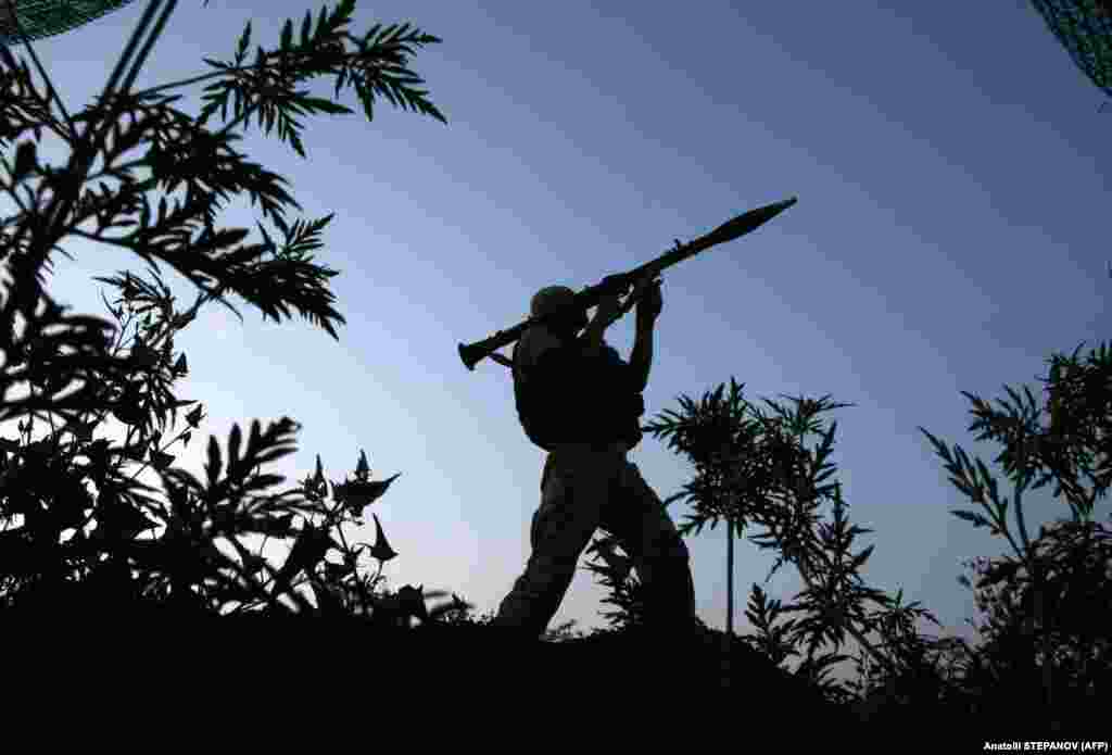 A Ukrainian soldier mans his position along the front line with Russia-backed separatists near the small town of Krasnogorivka in the Donetsk region.