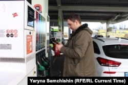 Микола Малуха на заправці у Києві демонструє додаток-калькулятор реальної вартості палива