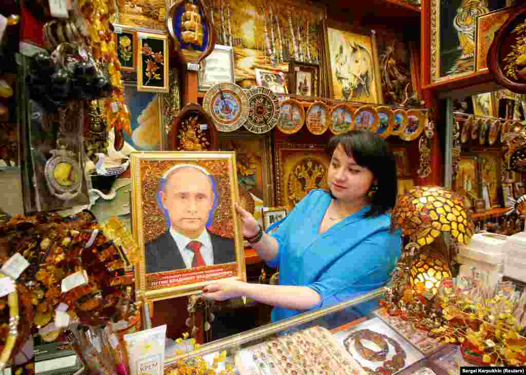 A vendor displays an "iconic" portrait of Russian President Vladimir Putin at a souvenir shop in Khrabrovo International Airport outside Kaliningrad, one of the host cities for the 2018 soccer World Cup. (Reuters/Sergei Karpukhin)