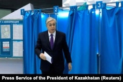 Kazakh President Qasym-Zhomart Toqaev walks out of a voting booth in Astana before casting his ballot on November 20.