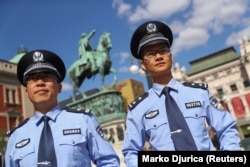 Chinese police officers stand at Belgrade’s Republic Square during joint patrol with Serbian police officers in 2019.