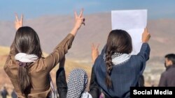 Three Iranian girls show their solidarity with protesters in the Kurdish city of Mahabad earlier this month amid the nationwide protests.