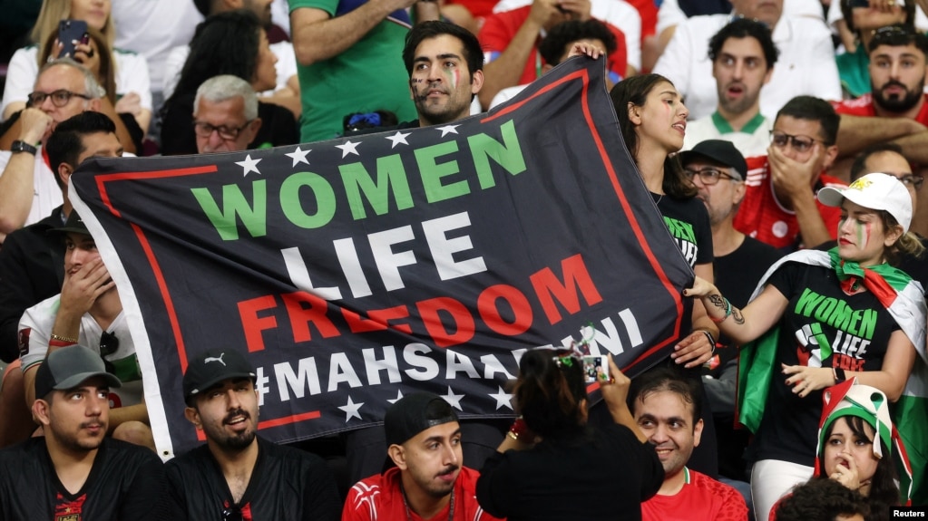 Iran fans hold a banner reading "Women, Life, Freedom" inside the stadium during Iran's first match in the World Cup in Qatar on November 21.