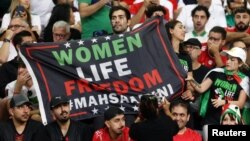 Iran fans hold a banner reading "Women, Life, Freedom" inside the stadium during Iran's first match in the World Cup in Qatar on November 21.