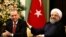 Turkish President Tayyip Erdogan (L) and Iranian President Hassan Rohani attend a joint news conference in Tehran, October 4, 2017
