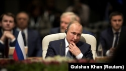 SOUTH AFRICA -- Russia's President Vladimir Putin looks on during the BRICS Summit in Johannesburg, South Africa, July 26, 2018. 