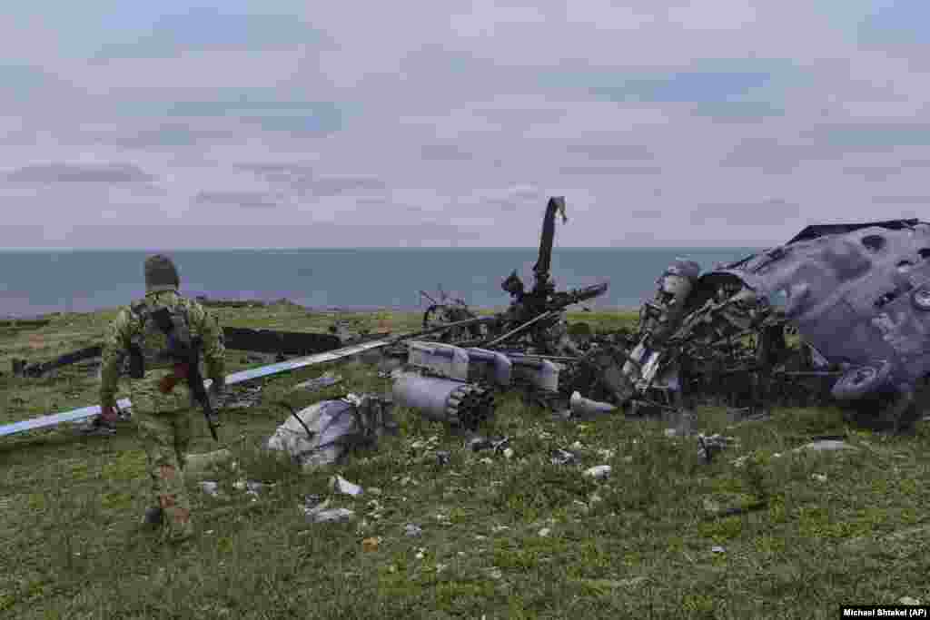 A destroyed helicopter on Snake Island. Video from May captured an Mi-8 helicopter fitted with rocket pods similar to those seen here being destroyed in a massive explosion as Russian troops gathered around the aircraft. &nbsp;