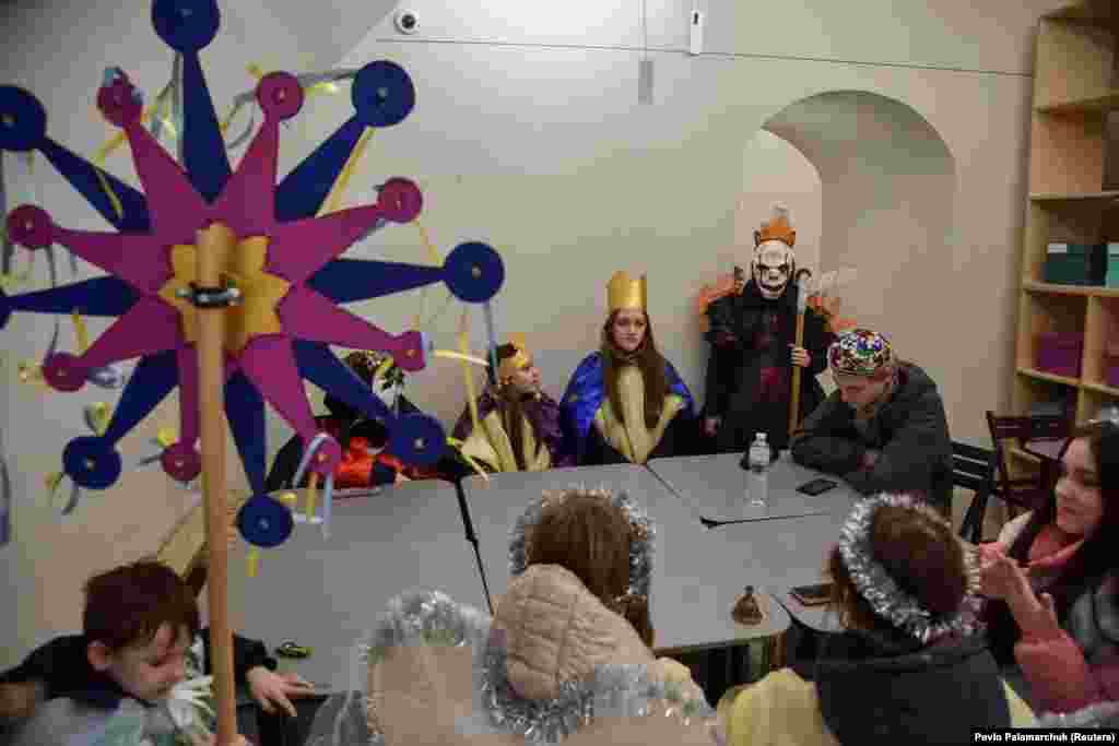 Children dressed in traditional Ukrainian costumes sit in a shelter during an air-raid alarm as they celebrate Orthodox Christmas in Lviv, Ukraine, on January 6.