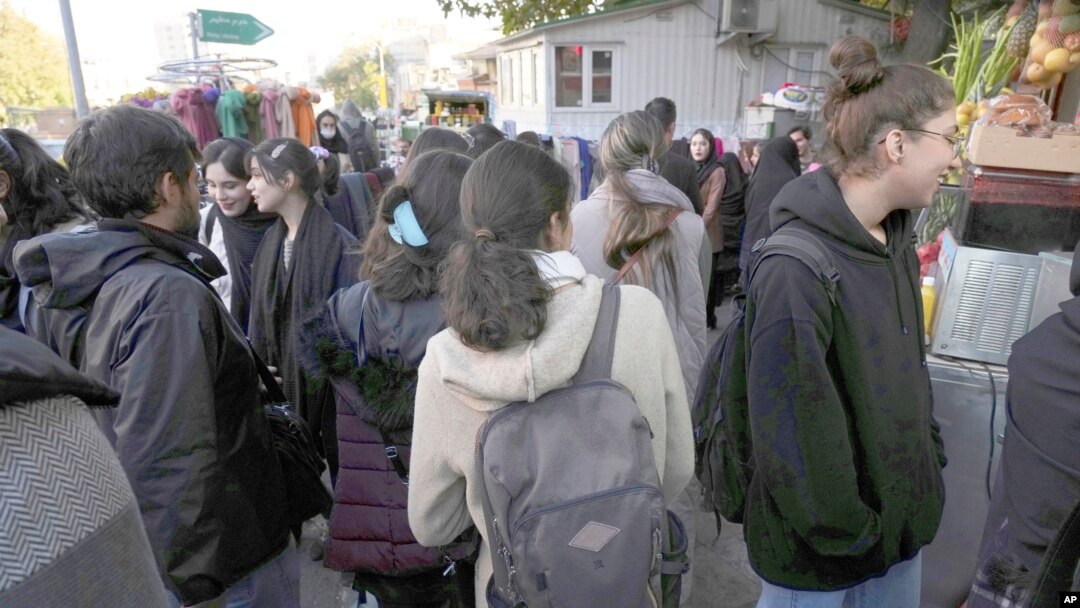 Iranian women walk in a commercial district of Tehran without wearing their mandatory Islamic head scarves. (file photo)