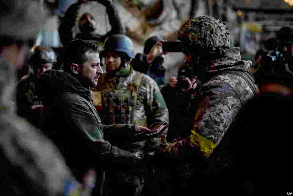Ukrainian President Volodymyr Zelenskiy (left) hands out a state award to one of his country&#39;s soldiers who is defending the eastern frontline city of Bakhmut.