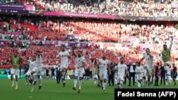 Iranian team players celebrate a victory against Wales at the Qatar 2022 World Cup.