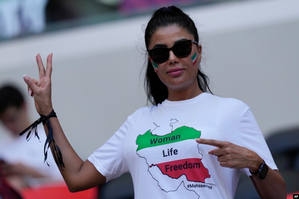 A fan wears a black ribbon and a T-shirt reading "Woman, life, freedom" in memory of Mahsa Amini prior to the match with Wales on November 25.