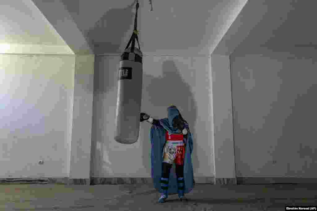 Portrait of an Afghan woman practices Muay Thai, or Thai boxing, in Kabul. Another woman, Sarina, 20, a mixed-martial artist, recalled how, in August 2021, she was competing in a local women&rsquo;s tournament at a Kabul sports hall. Word spread through the audience and participants that advancing Taliban fighters were on the city&rsquo;s outskirts. All the women and girls fled the hall. It was the last competition she ever played in.