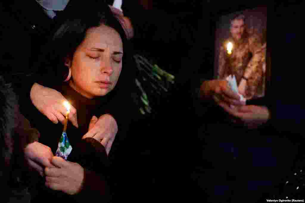 Olha reacts during a funeral ceremony for her husband, Volodymyr Yezhov, a Ukrainian soldier who was recently killed fighting Russian troops near the town of Bakhmut, in Kyiv on December 27.