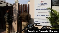 Police are seen at the gate of an office of Marion Biotech, a health-care and pharmaceutical company, in Noida, India, on December 29.