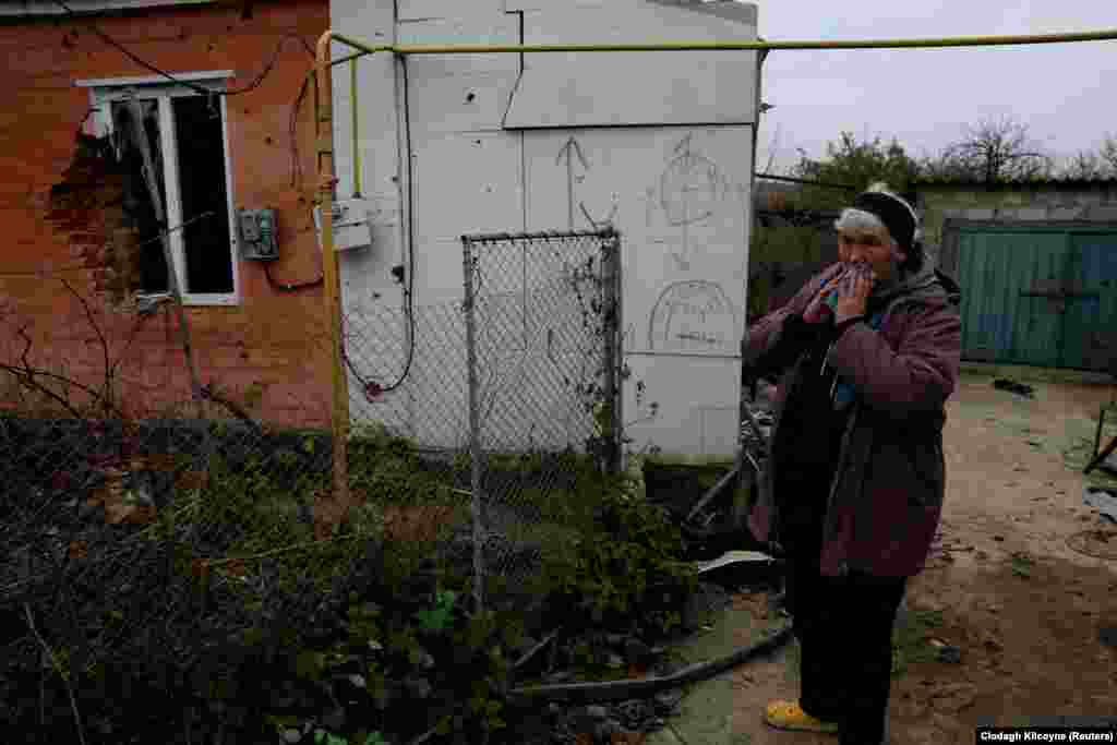 Nina reacts as she looks at the spot where her son, Oleksandr, was killed. In October, when Ukrainian forces marched back into Kamyanka following a counteroffensive, Oleksandr&#39;s body was exhumed and taken to the recaptured city of Izyum, where it was stored. &nbsp;