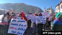 A group of veiled Afghan women marched through Kabul, carrying banners with slogans demanding rights, on November 24.
