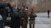 KFOR troops arrive at the scene of a roadblock in Rudare in northern Kosovo in late December.