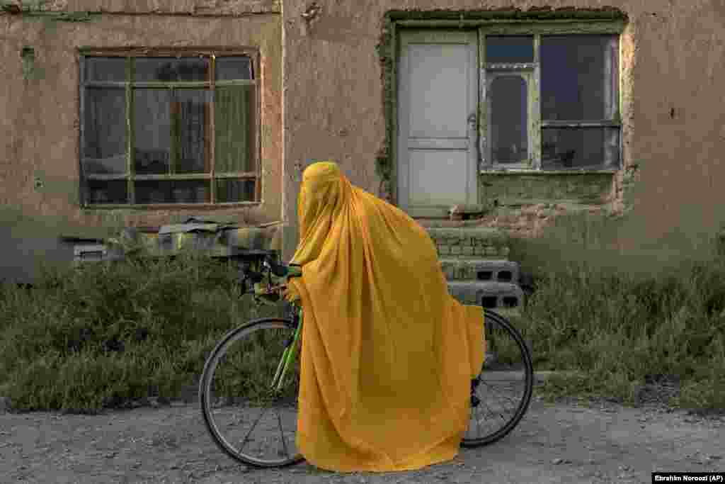 An Afghan woman with her racing bicycle in Kabul. The Taliban has also forbidden women from visiting parks or gyms and demands that they cover their faces and hair while they are out in public. They have also severely restricted women&#39;s capacity to work outside the home. Most recently, they banned women from working for nongovernmental organizations.