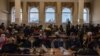 People gather at the railway station in Kherson as they charge their electronic devices and wait to board an evacuation train earlier this week. 