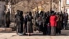 Afghan female students are stopped by Taliban security personnel stand next to a university in Kabul on December 21. 