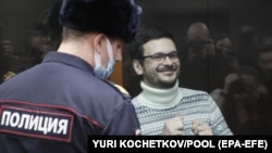 Russia oppositionist Ilya Yashin smiles for photographers before his 8 1/2 year prison sentence was announced in a Moscow court on December 9. 