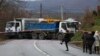 Local Serbs walk near a roadblock in Rudare, near the northern part of the ethnically divided town of Mitrovica, Kosovo, on December 13.