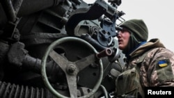 UKRAINE – A Ukrainian service member prepares to shoot from a howitzer at a front line, as Russia's attack on Ukraine continues, in Zaporizhzhia Region, December 16, 2022