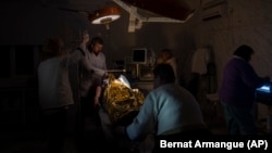Doctors operate on 13-year-old Artur Voblikov inside a hospital in Kherson, southern Ukraine, on November 22.