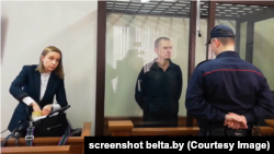 Andrzej Poczobut (center) attends a court hearing last month. 
