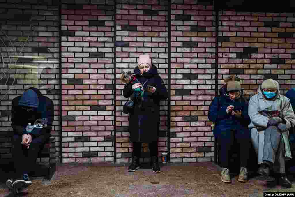 Civilians take shelter in an underground passage during an air-strike alert in the center of the Ukrainian capital, Kyiv.