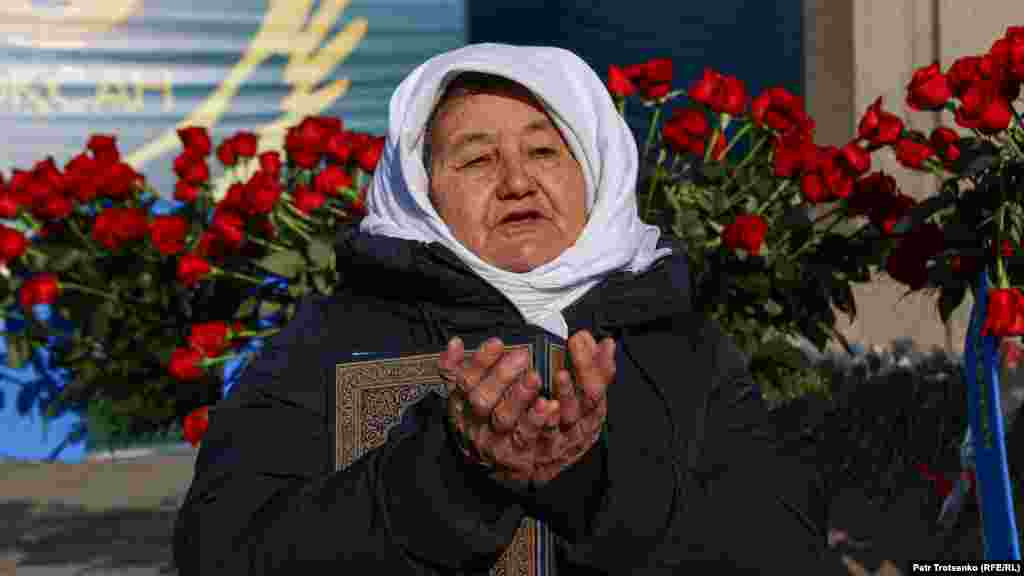 Пожилая женщина молится у монумента Независимости