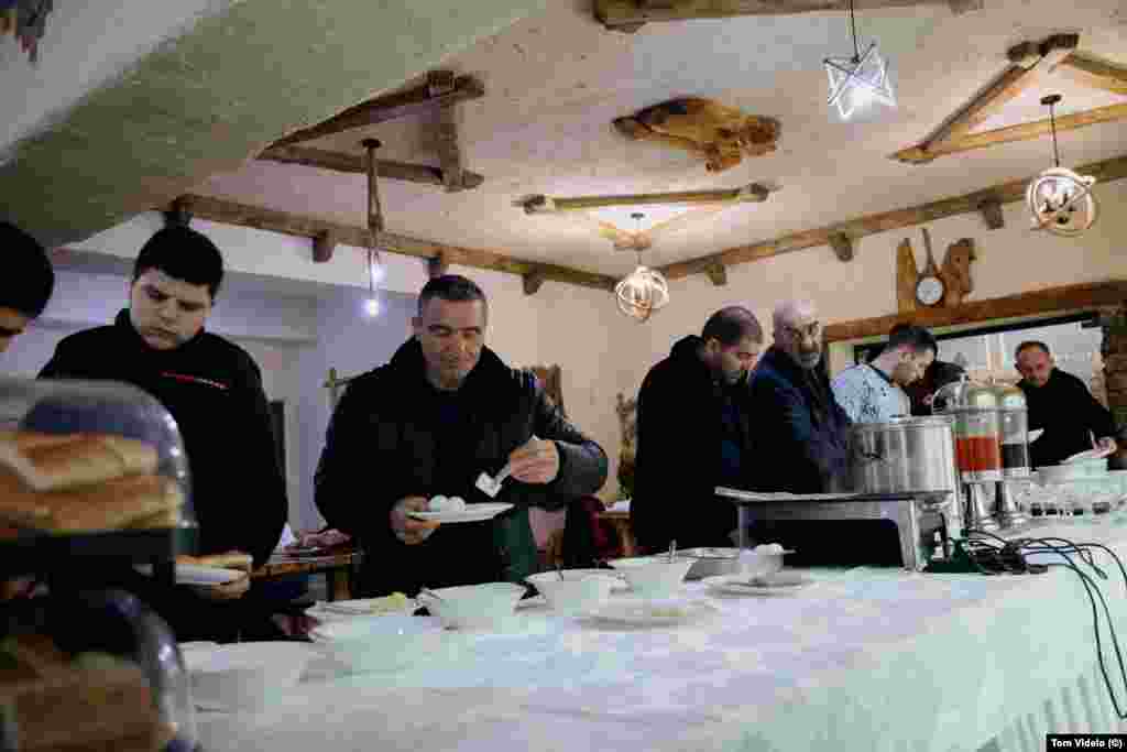 This December 29 photo shows ethnic Armenian locals from the breakaway Nagorno-Karabakh region of Azerbaijan queuing for breakfast in a hotel in Goris, southern Armenia, on the 18th day of being locked out of their hometowns.