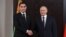 Turkmen President Serdar Berdymukhammedov (left) and Russian President Vladimir Putin shake hands during a meeting on the sidelines of the Shanghai Cooperation Organization in Samarkand, Uzbekistan, on September 15.