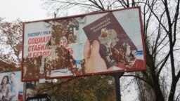 A ripped billboard promotes Russian passports in the Kherson city center.