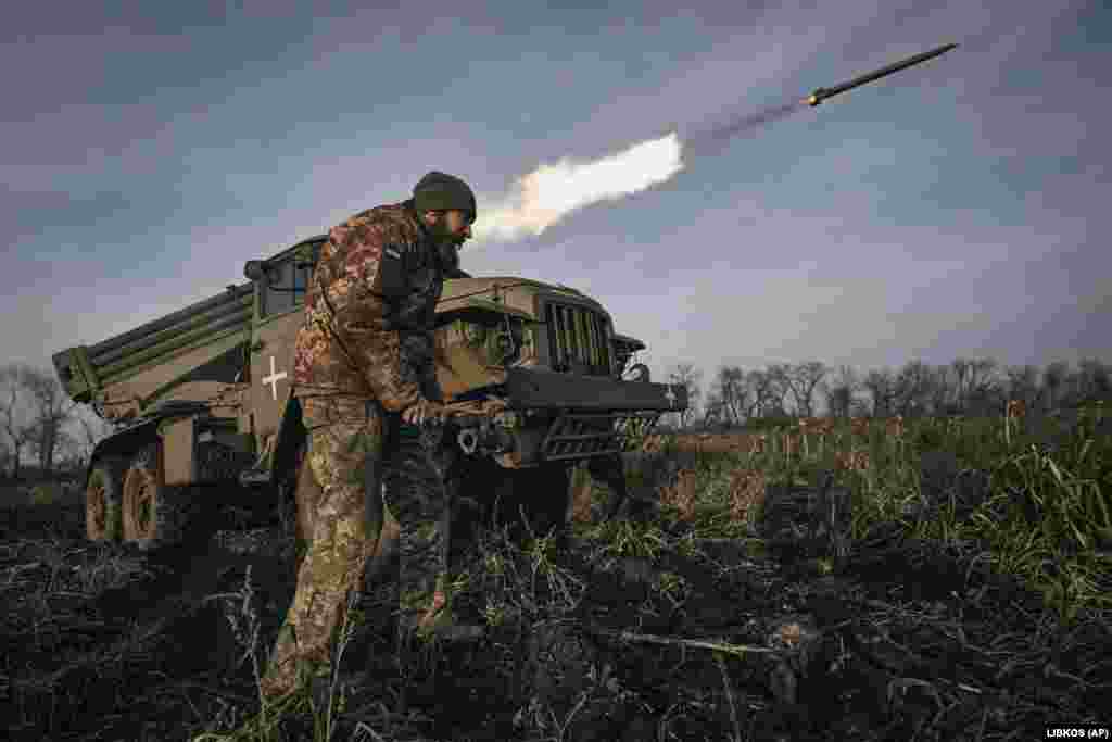 A Ukrainian soldier stands by as a Grad multiple-rocket launcher fires at Russian positions on the front line near Bakhmut, Donetsk region, Ukraine.