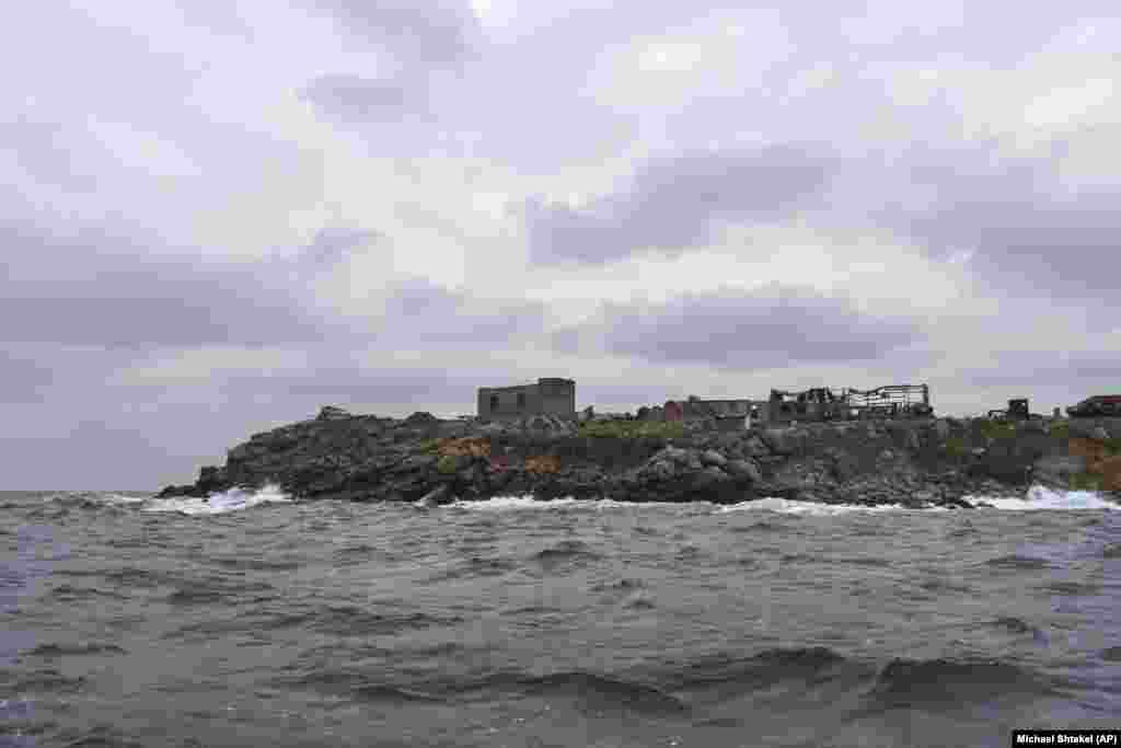 Ukraine&#39;s Snake Island is seen from an inflatable boat on December 18. The Ukrainian military gave a tour of Snake Island to RFE/RL correspondent Roman Pahulych, a photographer from AP, and a CNN film crew on December 18.